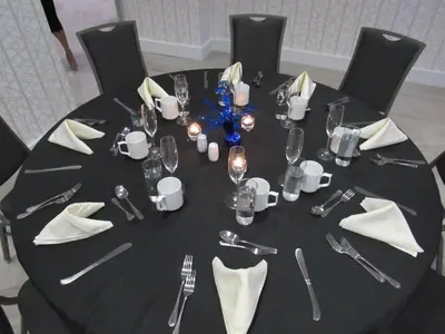 a round table with a black table cloth and silverware at Hilton Garden Inn Springfield in Springfield