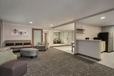 a large living room with a couch and a table at Hilton Garden Inn Springfield in Springfield