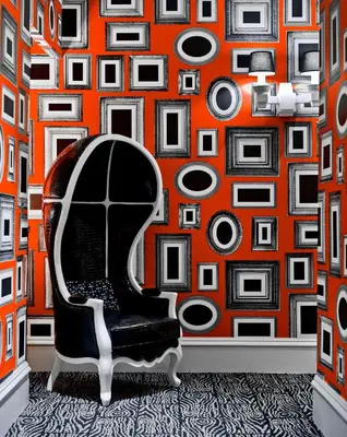a room with a chair and an orange wall at Moderne Hotel in New York