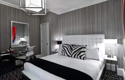 a bedroom with a large white bed and a desk at Moderne Hotel in New York