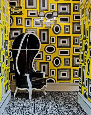 a room with a chair in front of a yellow wall at Moderne Hotel in New York