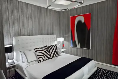 a bedroom with a white bed and a red painting at Moderne Hotel in New York