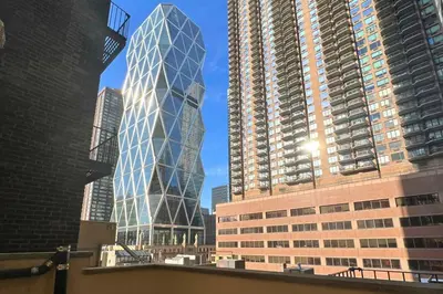 a tall glass building in the middle of two tall buildings at Moderne Hotel in New York