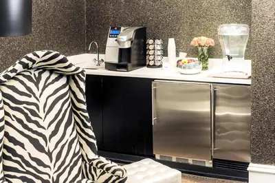 a kitchen with a counter with a stainless steel refrigerator at Moderne Hotel in New York
