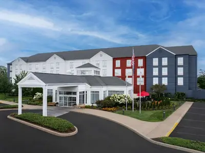 a large building with a flag in front of it at Hilton Garden Inn Wilkes-Barre in Wilkes-Barre