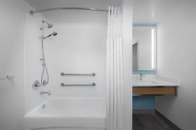 a bathroom with a shower and a sink at Hilton Garden Inn Wilkes-Barre in Wilkes-Barre