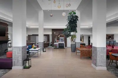 a lobby with couches and tables and chairs at Hilton Garden Inn Wilkes-Barre in Wilkes-Barre