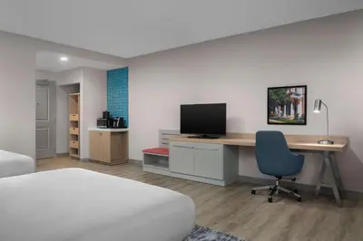 a bedroom with a desk with a computer and a bed at Hilton Garden Inn Wilkes-Barre in Wilkes-Barre