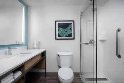 a bathroom with a toilet and a glass shower at Hilton Garden Inn Wilkes-Barre in Wilkes-Barre
