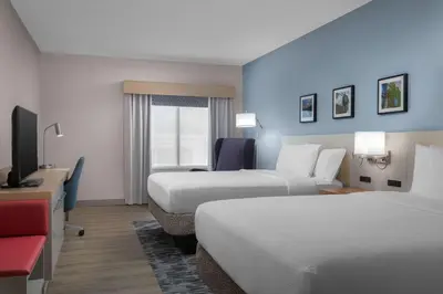 a hotel room with two beds and a television at Hilton Garden Inn Wilkes-Barre in Wilkes-Barre