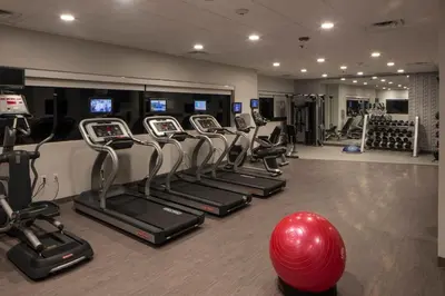 a gym with a row of cardio machines and a red ball at Hotel Indigo Harrisburg - Hershey by IHG in Harrisburg