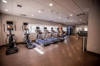 a gym with treadmills and elliptical machines at Hotel Indigo Harrisburg - Hershey by IHG in Harrisburg