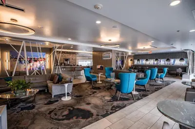 a hotel lobby with blue chairs and a bar at Hotel Indigo Harrisburg - Hershey by IHG in Harrisburg