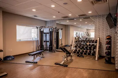 a gym with several treadmills and weights at Hotel Indigo Harrisburg - Hershey by IHG in Harrisburg