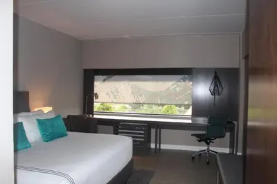 a hotel room with a bed and a window at Hotel Indigo Harrisburg - Hershey by IHG in Harrisburg
