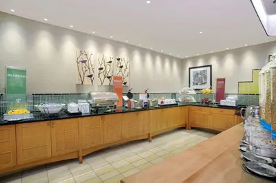 a restaurant with a counter with food on it at Hampton Inn Middletown in Middletown