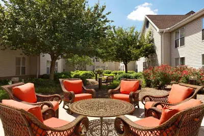 a patio with wicker chairs and a table at Homewood Suites Harrisburg-West Hershey Area in Mechanicsburg