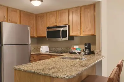 a kitchen with a white refrigerator and a sink at Homewood Suites Harrisburg-West Hershey Area in Mechanicsburg