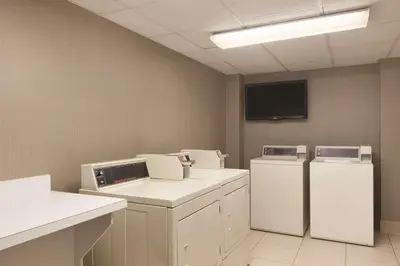 a laundry room with two refrigerators and a tv at Homewood Suites Harrisburg-West Hershey Area in Mechanicsburg