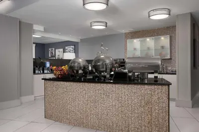 a bar with two football helmets on top of it at Homewood Suites by Hilton Reading-Wyomissing in Wyomissing