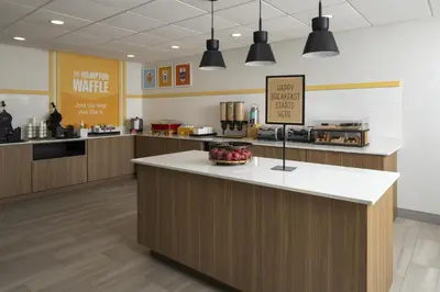 a kitchen with a counter with a bowl of fruit on it at Hampton Inn - York in York