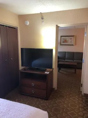 a hotel room with a television and a couch at Hampton Inn - York in York
