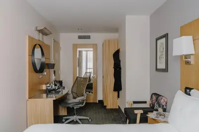 a hotel room with a bed and a desk at Club Quarters Hotel World Trade Center, New York in New York