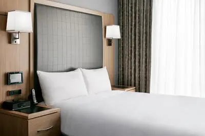 a bedroom with a large white bed and a window at World Center Hotel in New York