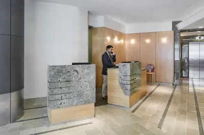 a man standing at a counter in a lobby at World Center Hotel in New York