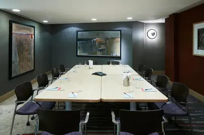 a conference room with a large table and chairs at World Center Hotel in New York