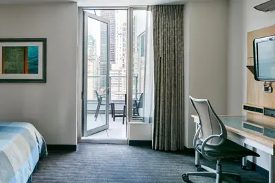 a hotel room with a bed and a sliding glass door at World Center Hotel in New York