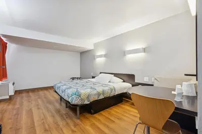 a hotel room with a bed and a table at Motel 6-Piscataway, NJ in Piscataway