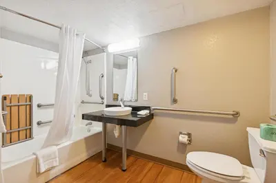 a bathroom with a sink and a toilet and a tub at Motel 6-Piscataway, NJ in Piscataway