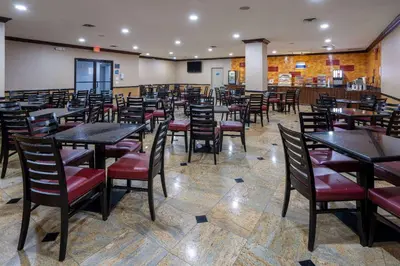 a dining room filled with tables and chairs at Days Hotel by Wyndham North Bergen in North Bergen