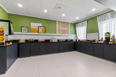 a waiting area in a dental office with green walls at Spark By Hilton Bensalem Philadelphia in Bensalem