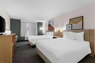 a hotel room with two beds and a television at Spark By Hilton Bensalem Philadelphia in Bensalem