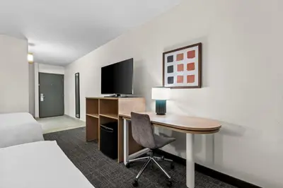 a hotel room with a desk and a bed at Spark By Hilton Bensalem Philadelphia in Bensalem