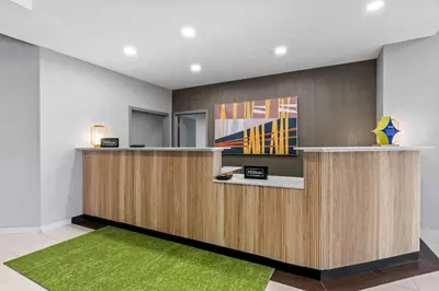 an office with a reception desk with a green rug at Spark By Hilton Bensalem Philadelphia in Bensalem
