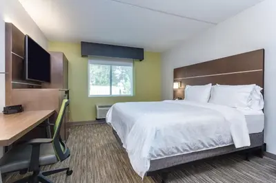 a hotel room with a bed and a desk and a computer at Holiday Inn Express Exton - Great Valley by IHG in Exton