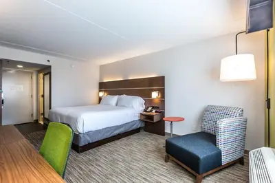 a hotel room with a bed and a chair at Holiday Inn Express Exton - Great Valley by IHG in Exton