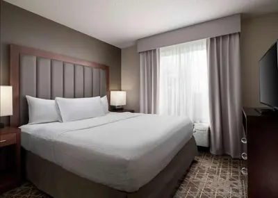 a bedroom with a large bed and a large window at Homewood Suites by Hilton Somerset in Somerset