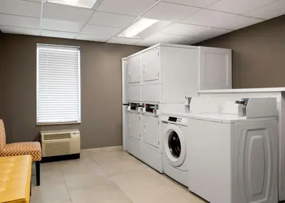 a laundry room with a washing machine and a window at Homewood Suites by Hilton Somerset in Somerset