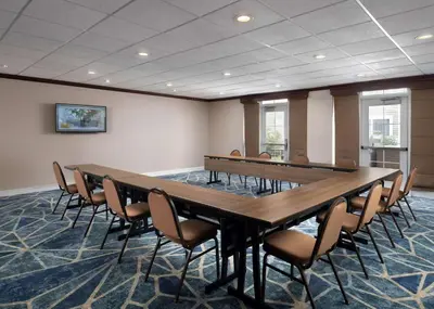 a conference room with a long table and chairs at Homewood Suites by Hilton Somerset in Somerset