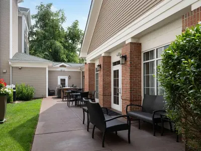 a patio with chairs and tables on a house at Homewood Suites by Hilton Somerset in Somerset