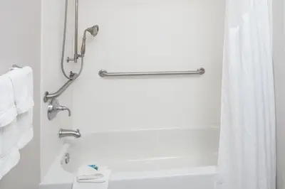 a bathroom with a white tub and a shower at Holiday Inn Express Haskell-Wayne Area by IHG in Haskell