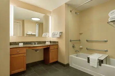 a bathroom with a tub and a sink and a shower at Homewood Suites by Hilton Allentown-Bethlehem Airport in Bethlehem