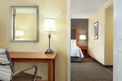 a hotel room with a desk and a bed at Homewood Suites by Hilton Allentown-Bethlehem Airport in Bethlehem