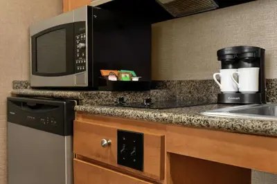 a kitchen with a microwave and a sink at Homewood Suites by Hilton Allentown-Bethlehem Airport in Bethlehem