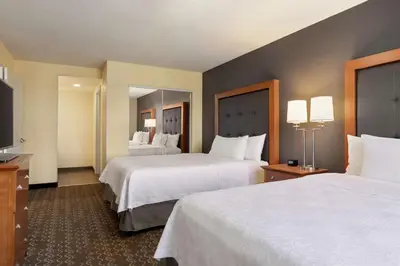 a hotel room with two beds and a television at Homewood Suites by Hilton Allentown-Bethlehem Airport in Bethlehem