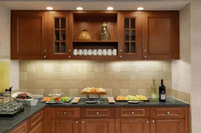 a kitchen with wooden cabinets and food on a counter at Homewood Suites by Hilton Allentown-Bethlehem Airport in Bethlehem